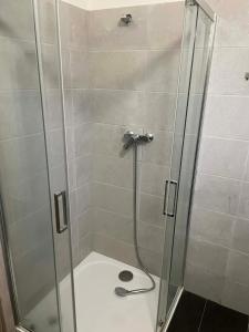a shower stall with a glass door with a shower at Ubytování Jimramov in Jimramov