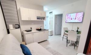a living room with a kitchen and a dining room at Apartman Pavlica in Kragujevac