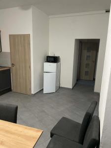 a living room with a couch and a table and a kitchen at Ubytování Jimramov in Jimramov
