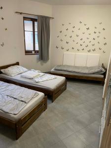 two beds in a room with birds on the wall at Ubytování Jimramov in Jimramov
