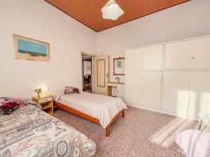 a bedroom with two beds and a large closet at Orchidea 2 - Pineto Vacanza in Pineto