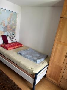 a bed in a room next to a door at Zimmer mit Aussicht, Gstaltenrain 19 in Kaiseraugst
