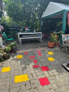 a patio with red and yellow paint on it at Zimmer mit Aussicht, Gstaltenrain 19 in Kaiseraugst