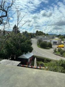 a view of a street with a road and a building at Zimmer mit Aussicht, Gstaltenrain 19 in Kaiseraugst