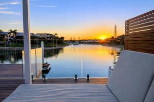 a view of a river from a room with a bed at Saltwater Villas - Pet Friendly Accommodation in Mooloolaba