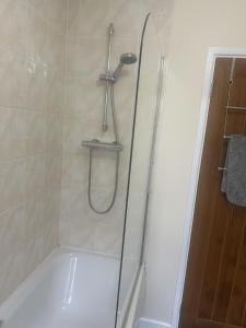 a shower with a glass door in a bathroom at Willow Valley in Bude +31 photos