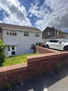 a white car parked in front of a house at 3 bed house in Risca in Risca