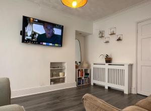 a living room with a flat screen tv on the wall at 3 bed house in Risca in Risca