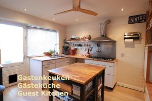 a kitchen with a stove and a counter top at Boutique hotel Zeelui in Egmond aan Zee