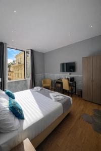 a bedroom with a large bed and a large window at Bramble Luxury Suites in Rome
