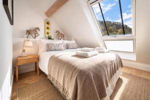 a bedroom with a bed and a large window at Tors Park in Lynmouth