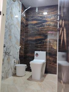 a bathroom with a toilet and a sink at SRC Mahal in Killai