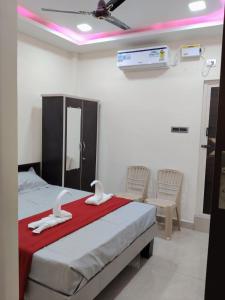 a bedroom with a bed with white towels on it at SRC Mahal in Killai