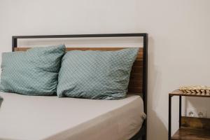 a bed with two pillows on top of it at Boho Loft Apartment am Ziegeltor in Amberg
