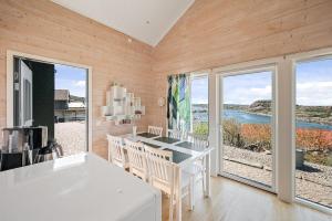 a dining room with a table and views of the ocean at Fantastisk havsutsikt i Ulebergshamn in Hunnebostrand