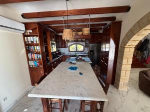 a kitchen with a large marble table in a room at Onirozo Koroni Private Villa in Koroni