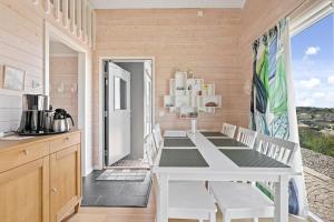 a dining room with a white table and chairs at Fantastisk havsutsikt i Ulebergshamn in Hunnebostrand +17 photos