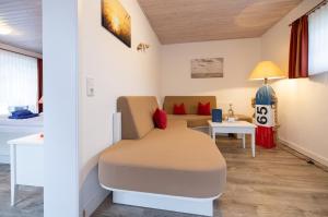 a hospital room with a bed and a table at Hotel Anka in Norddorf