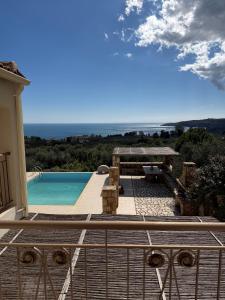 a view of a swimming pool from the balcony of a house at Onirozo Koroni Private Villa in Koroni