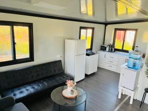 a living room with a black couch and a kitchen at Beautiful Pradise 1 in Penfield