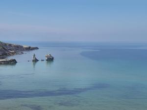 a large body of water with rocks in it at Casa Frufa in Terrasini
