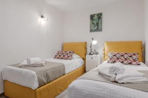 a bedroom with two beds with towels on them at Villa Saktouris in Saktoúria +34 photos