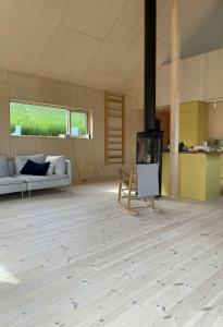 a living room with a couch and a fireplace at Architect-Designed Cabin With Beach Nearby in Lensvik +19 photos