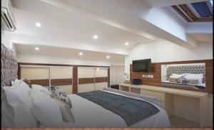 a bedroom with a large bed and a television at Central luxury duplex in Cannes