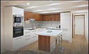 a kitchen with white cabinets and a stove top oven at Central luxury duplex in Cannes +3 photos