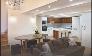 a living room with a couch and a table at Central luxury duplex in Cannes