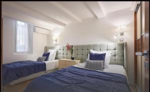 two beds in a room with blue and white at Central luxury duplex in Cannes