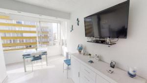 a living room with a large flat screen tv on a wall at Holiday 3401 in Roses