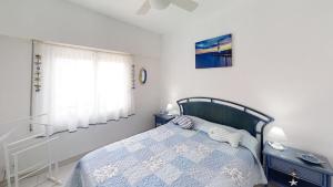 a bedroom with a bed and a window at Holiday 3401 in Roses +17 photos