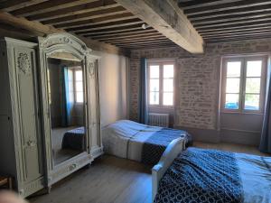 a bedroom with two beds and a large mirror at Chez Marine & Justine in Charolles