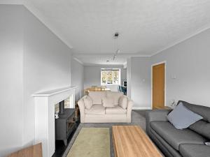 a living room with a couch and a fireplace at Modern Contractor House - Lockable Gated Parking in Kiveton Park