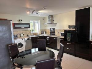 a kitchen with a table and chairs in a kitchen at Cambrian View in Aberystwyth