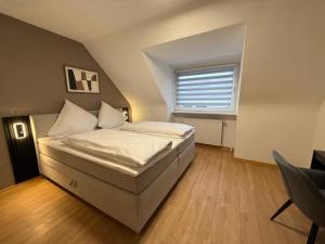 a bedroom with a large bed with a window at Shin Central Self-Check-in in Essen