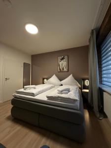 a bedroom with two beds and a window at Shin Central Self-Check-in in Essen