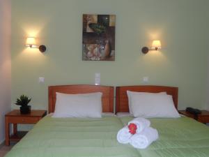a bedroom with a bed with towels on it at Filoxenia Marias in Loutra Ipatis