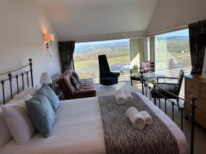 a bedroom with a large bed and a large window at Cambrian View in Aberystwyth +43 photos