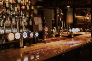 a bar with a bunch of bottles of alcohol at The Half Moon Inn in Dean