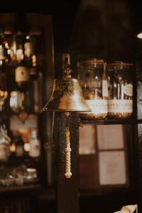 a bell on a pole in a room with jars at The Half Moon Inn in Dean