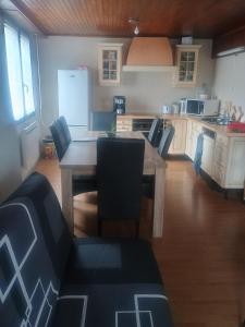 a kitchen with a wooden table and chairs in it at Maison neuvecelle in Neuvecelle