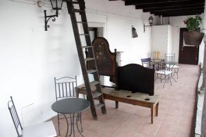 a room with a ladder and chairs and tables at Casa Clerici - Cà del merican in Nonio +26 photos