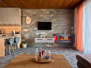 a living room with a brick wall with a fireplace at Apartmány Hrabušice in Hrabušice