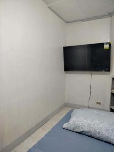 a room with a flat screen tv on the wall at Cebu Cozy Affordable Transient Room Wifi Netflix Shower Heater in Cebu City