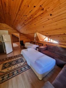a bedroom with a large bed in a wooden ceiling at Şahmeran Pansiyon in Kemer