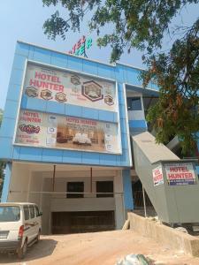 a building with a billboard in front of it at Hotel Hunter in Bārdoli