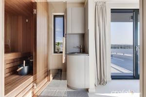 a bathroom with a toilet and a window at Villa Tamaris- 10 mins from Zadar in Zadar