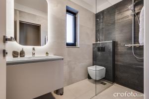 a bathroom with a toilet and a sink and a shower at Villa Tamaris- 10 mins from Zadar in Zadar